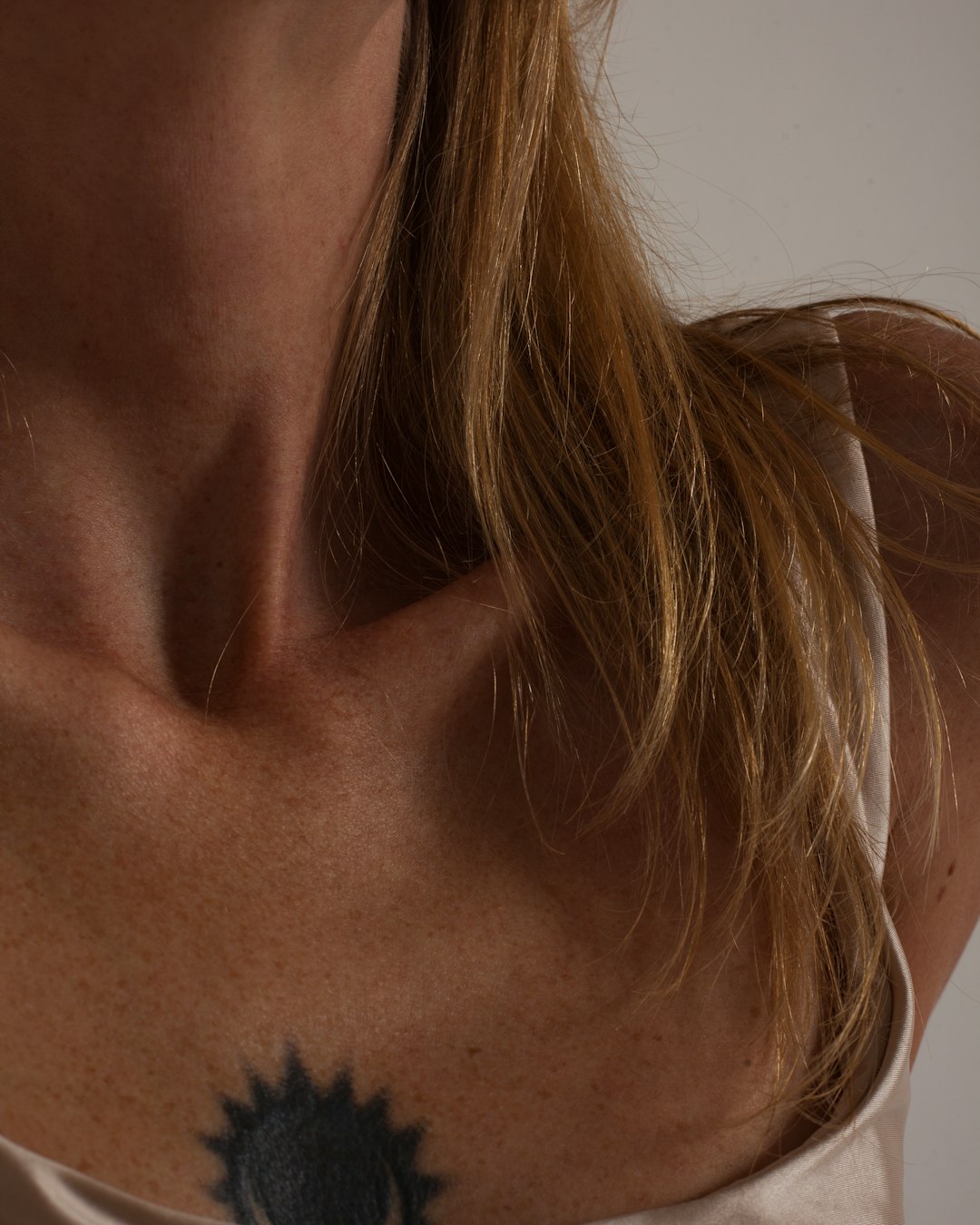 woman with black tattoo on her neck