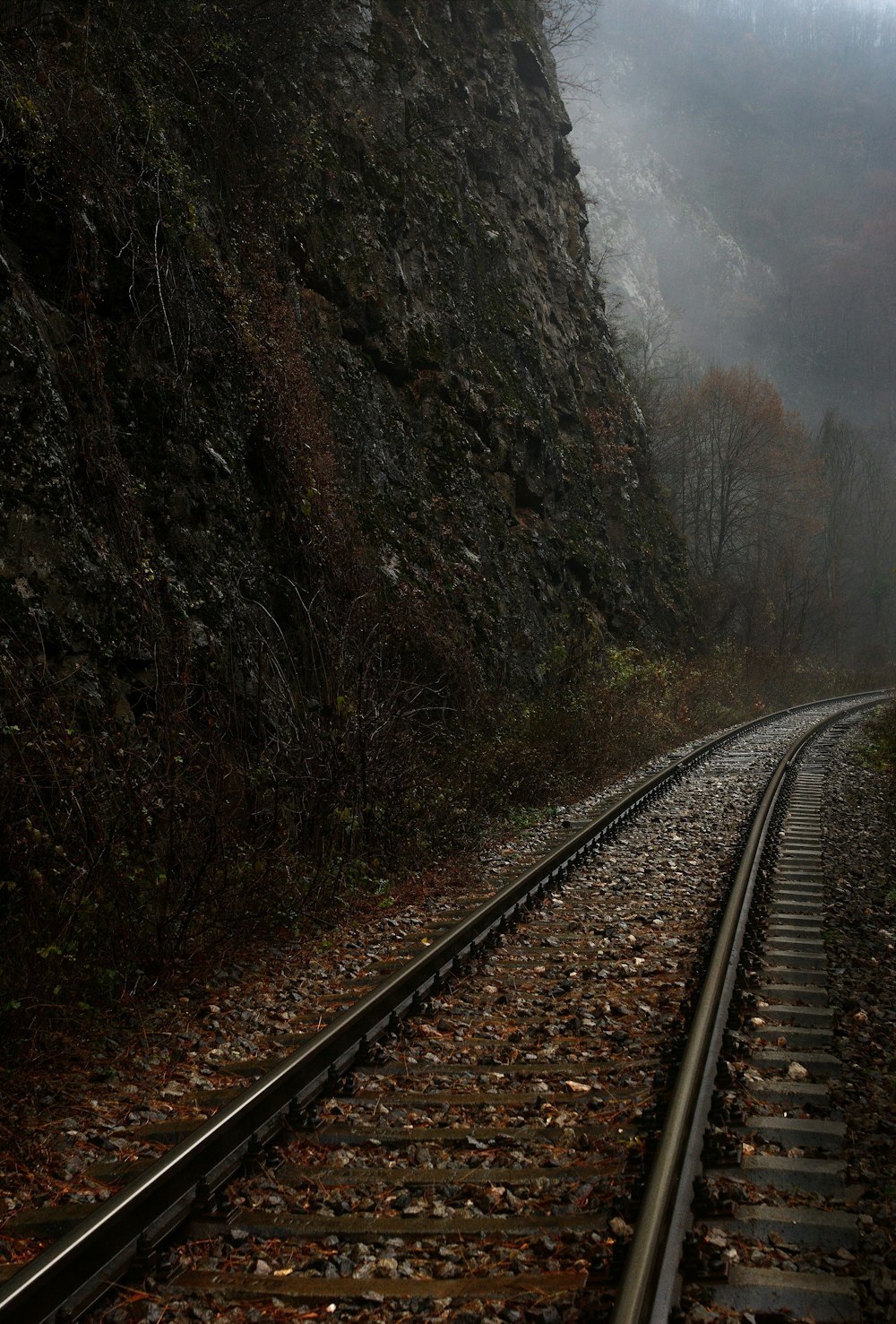 train rail near mountain during daytime