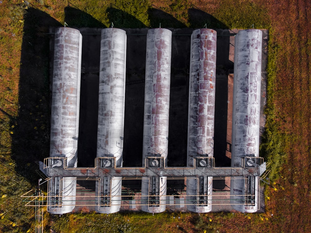 gray metal pipe lot on green grass field during daytime