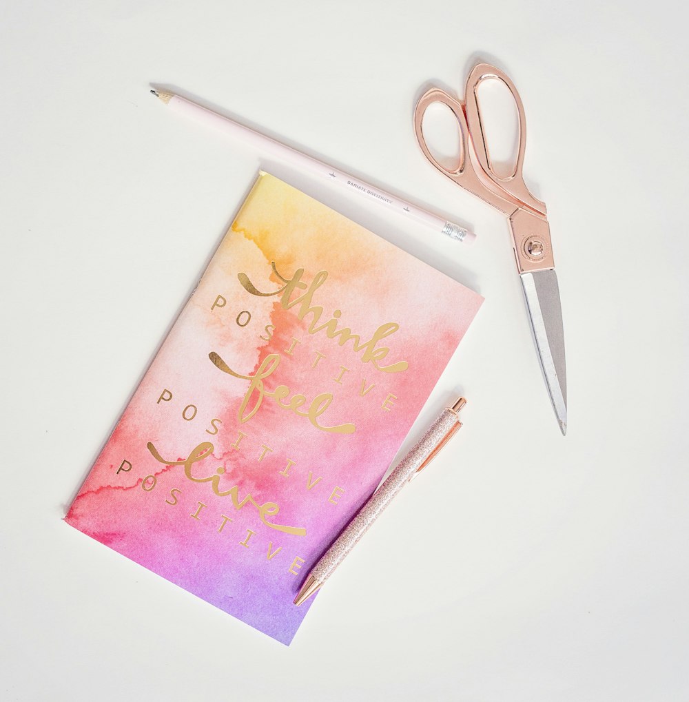 silver scissors on pink paper
