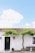 white concrete house with green plants