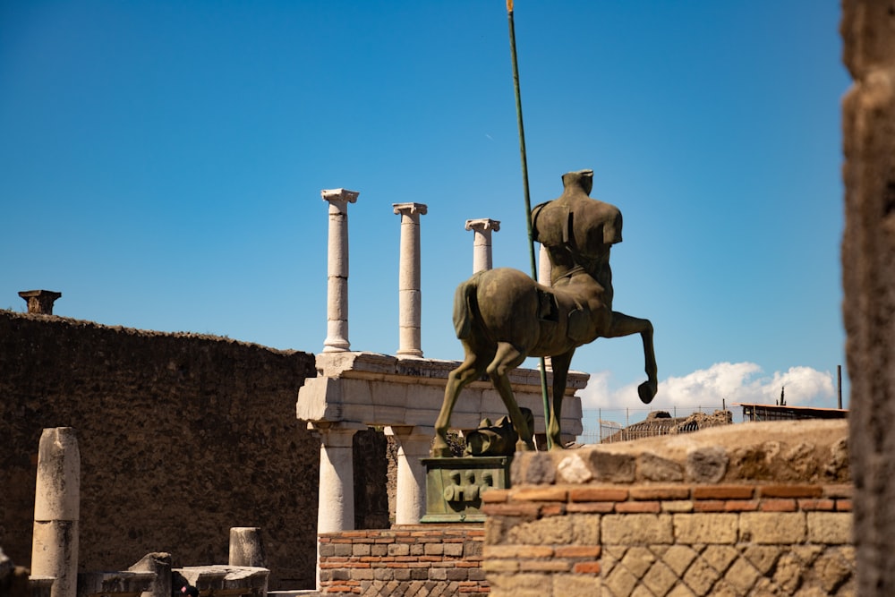 gray horse statue under blue sky during daytime