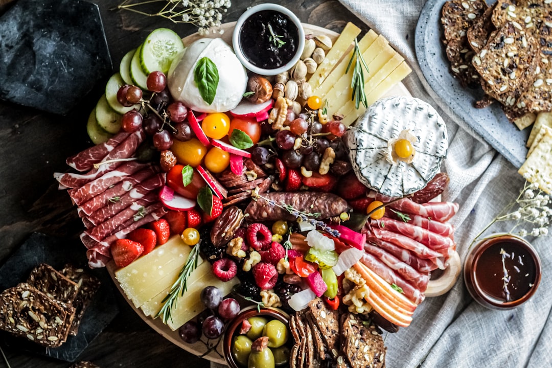 sliced fruits on brown wooden bowl, Grazing platter - Cheese & Charcuterie board