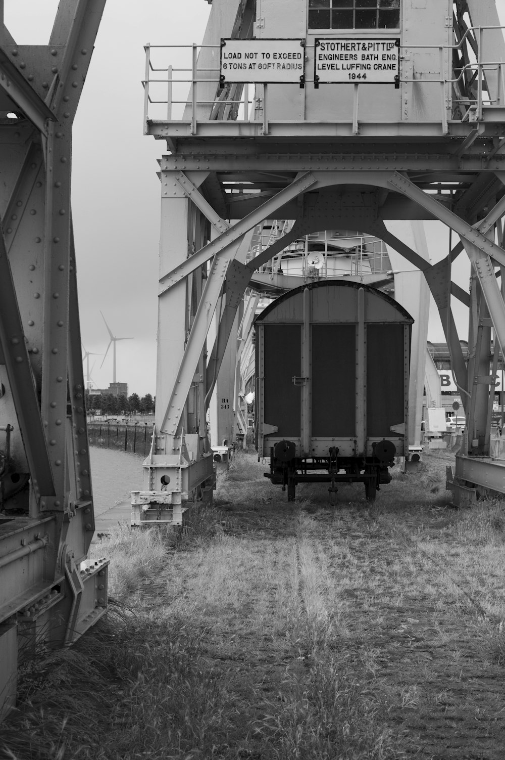 grayscale photo of a metal bridge