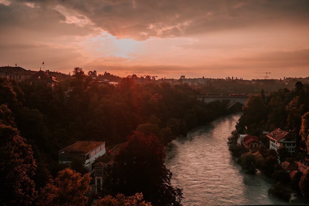 white and brown house near river during sunset