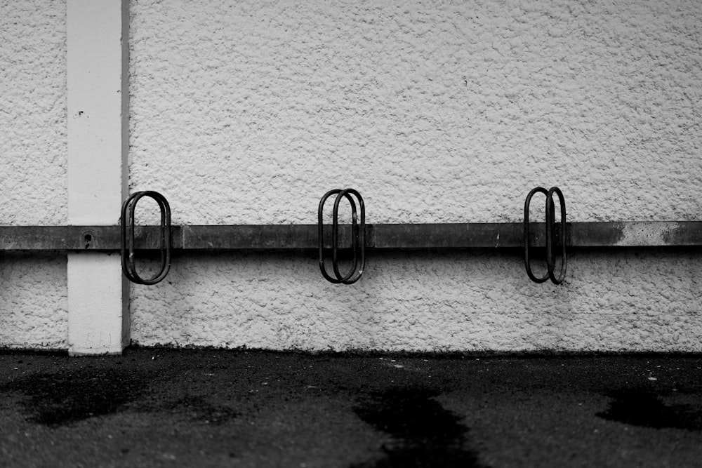 black metal fence on white concrete wall