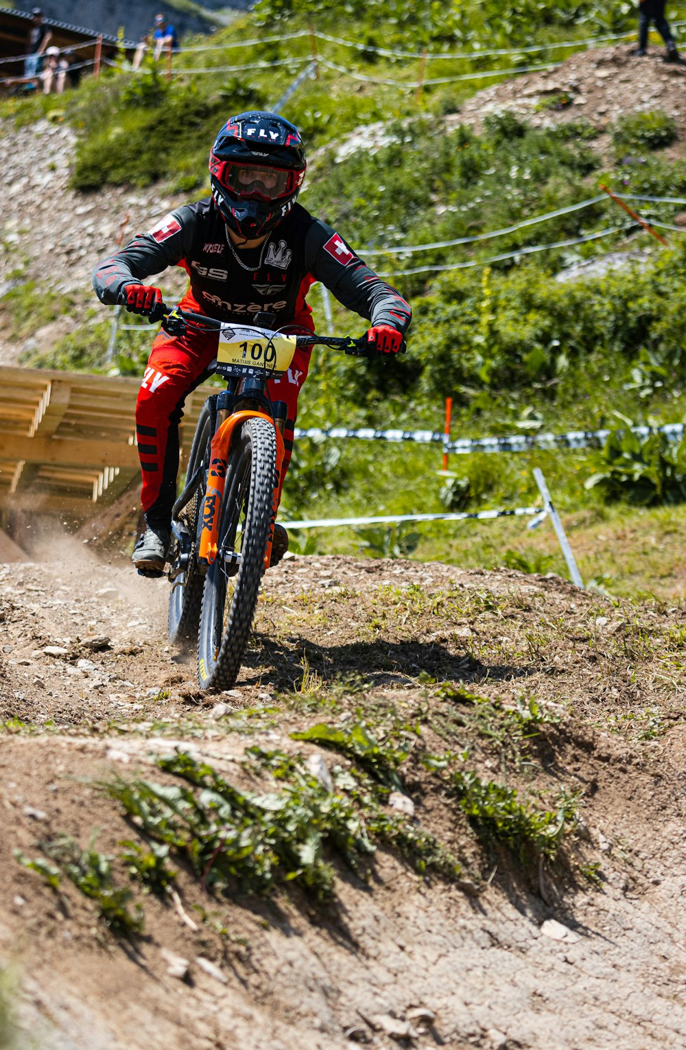 man in black and red jacket riding on red mountain bike during daytime