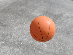 A dynamic mid-air shot of a player leaping to control the ball against a minimalist black and white background.