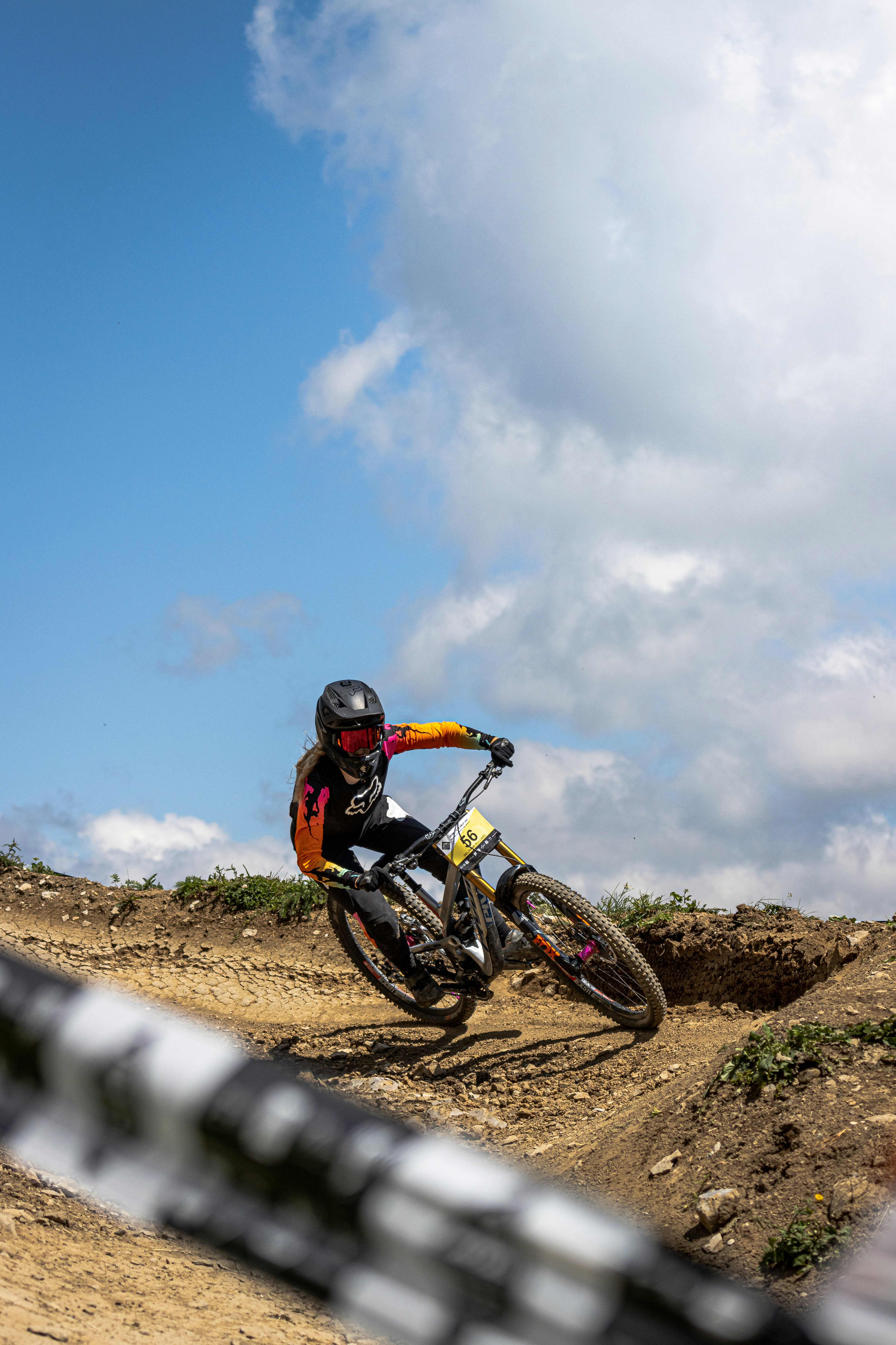 man riding motocross dirt bike on dirt road during daytime