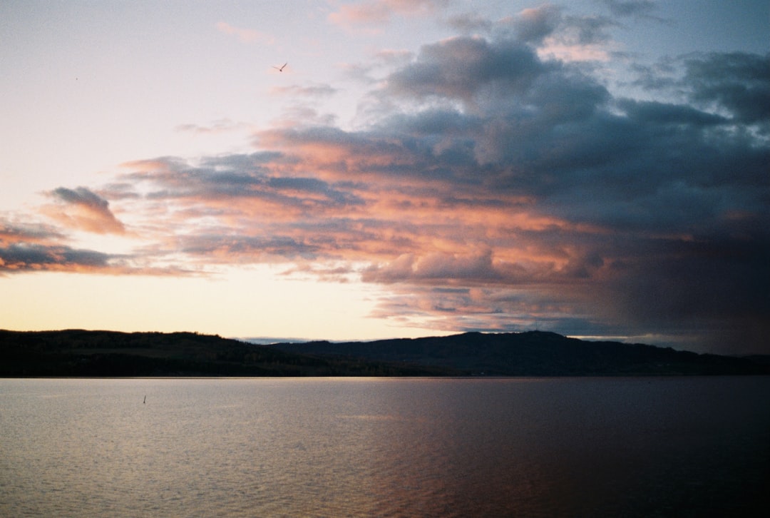 body of water under cloudy sky during daytime