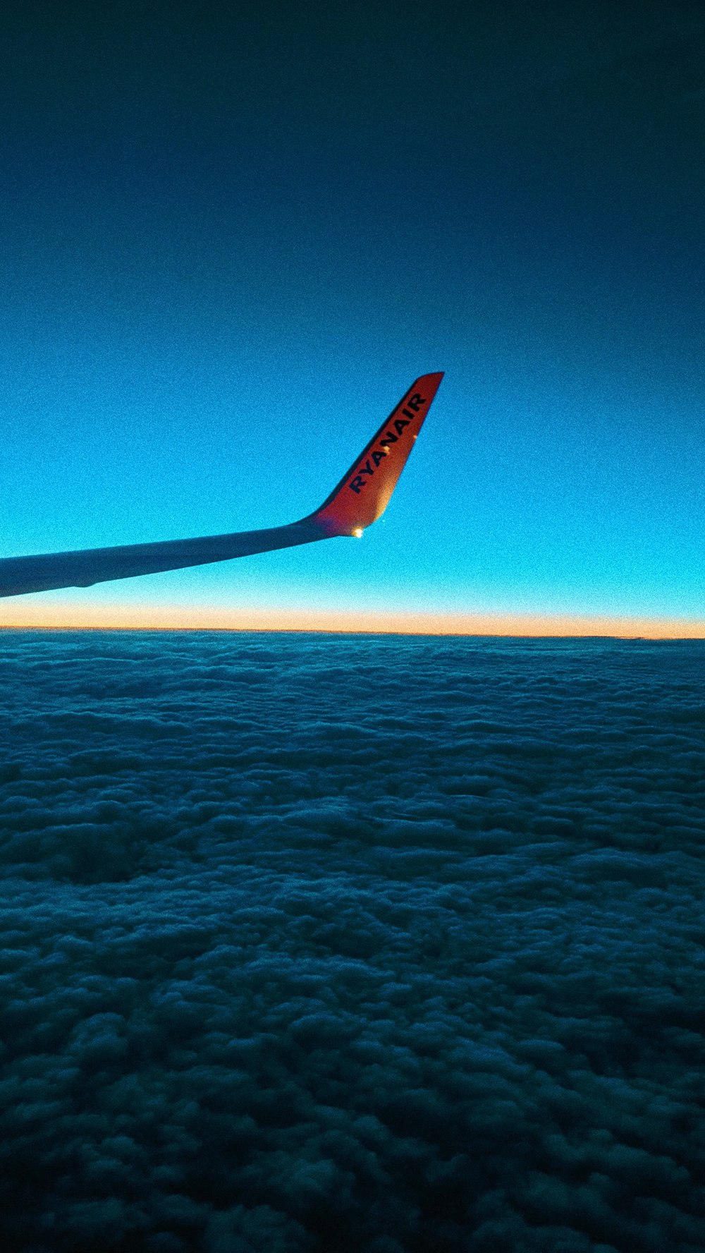 airplane wing over the sea during daytime