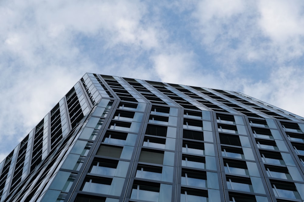 white and black concrete building under white clouds during daytime