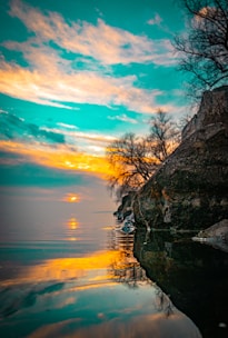 A calm lakeside scene at sunset with no people, reflecting peaceful emptiness.