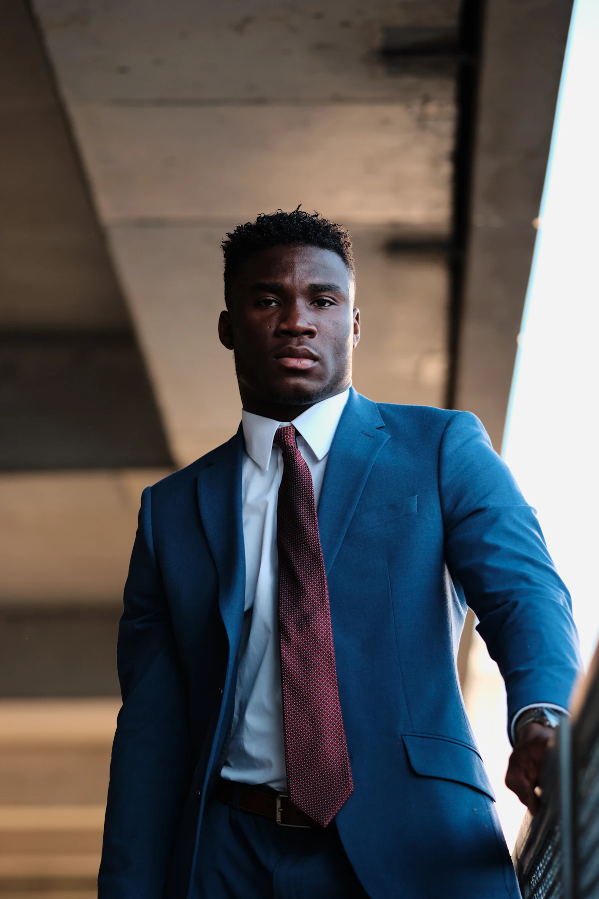 Man in blue suit jacket and red necktie