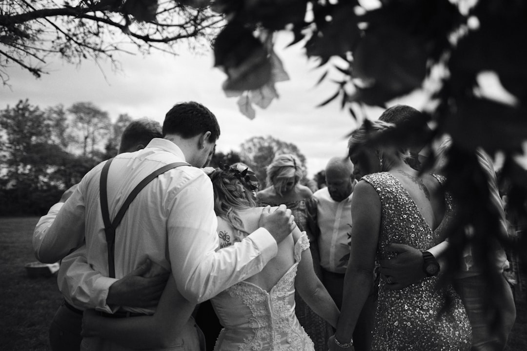 grayscale photo of man and woman kissing