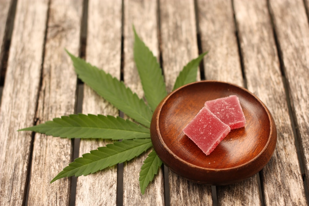 cannabis gummy edible on gray wooden surface