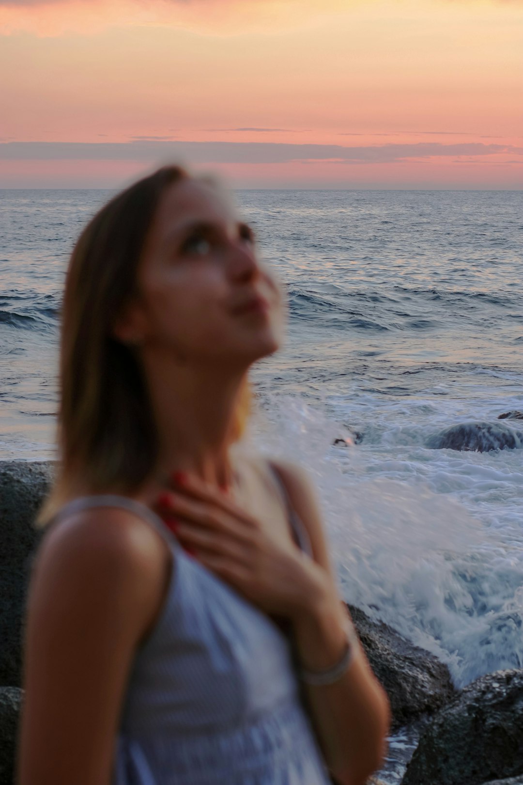 woman in white tank top on beach during daytime