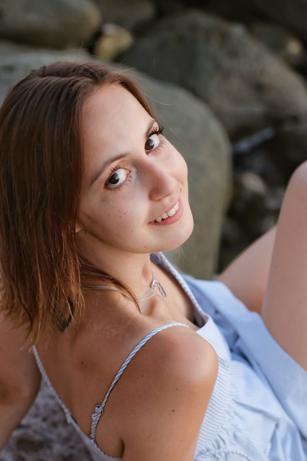 woman in white tank top smiling