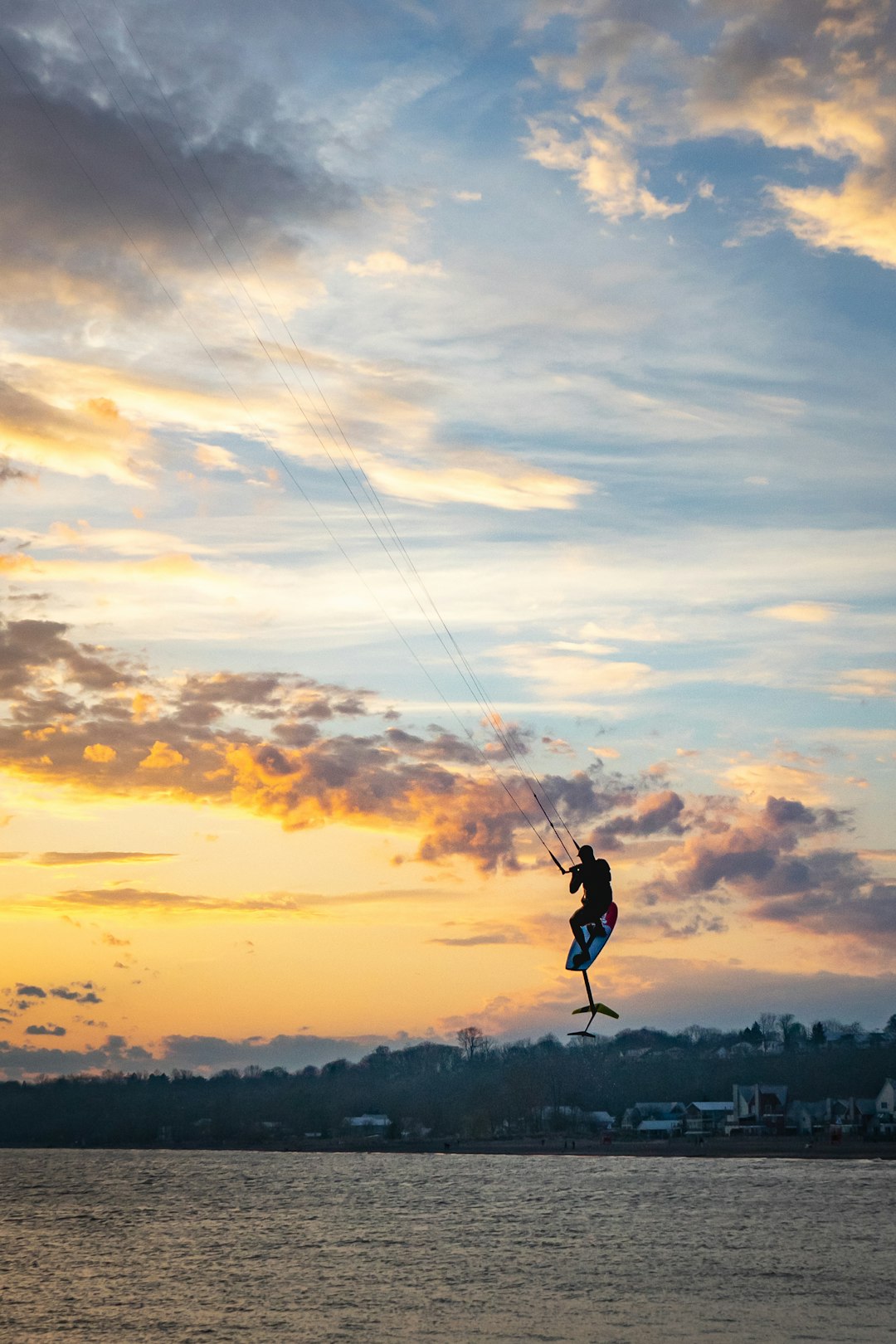 silhouette of person riding on parachute during sunset