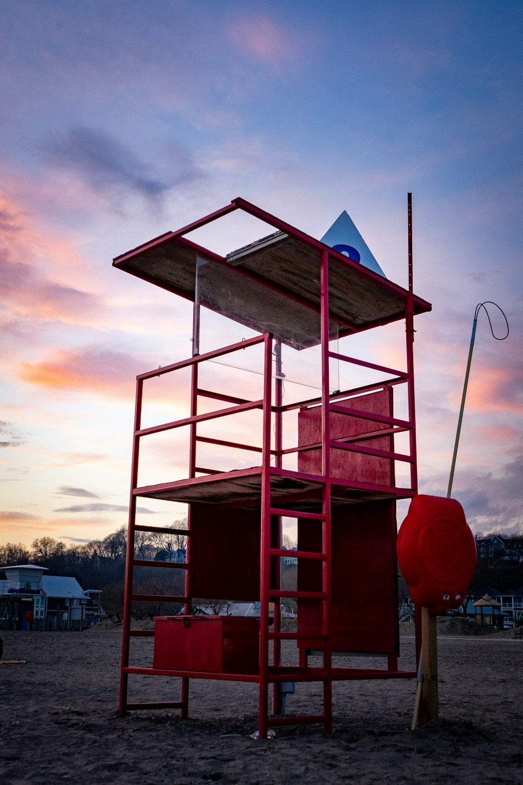 red and white wooden lifeguard tower