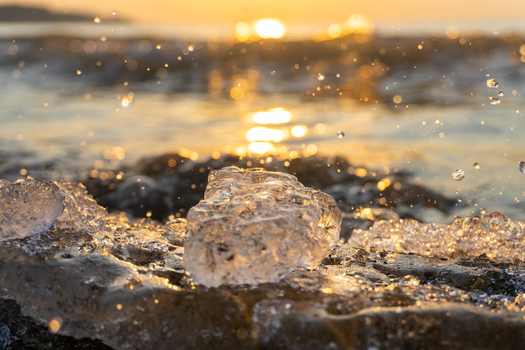 white and gray stone on seashore during sunset