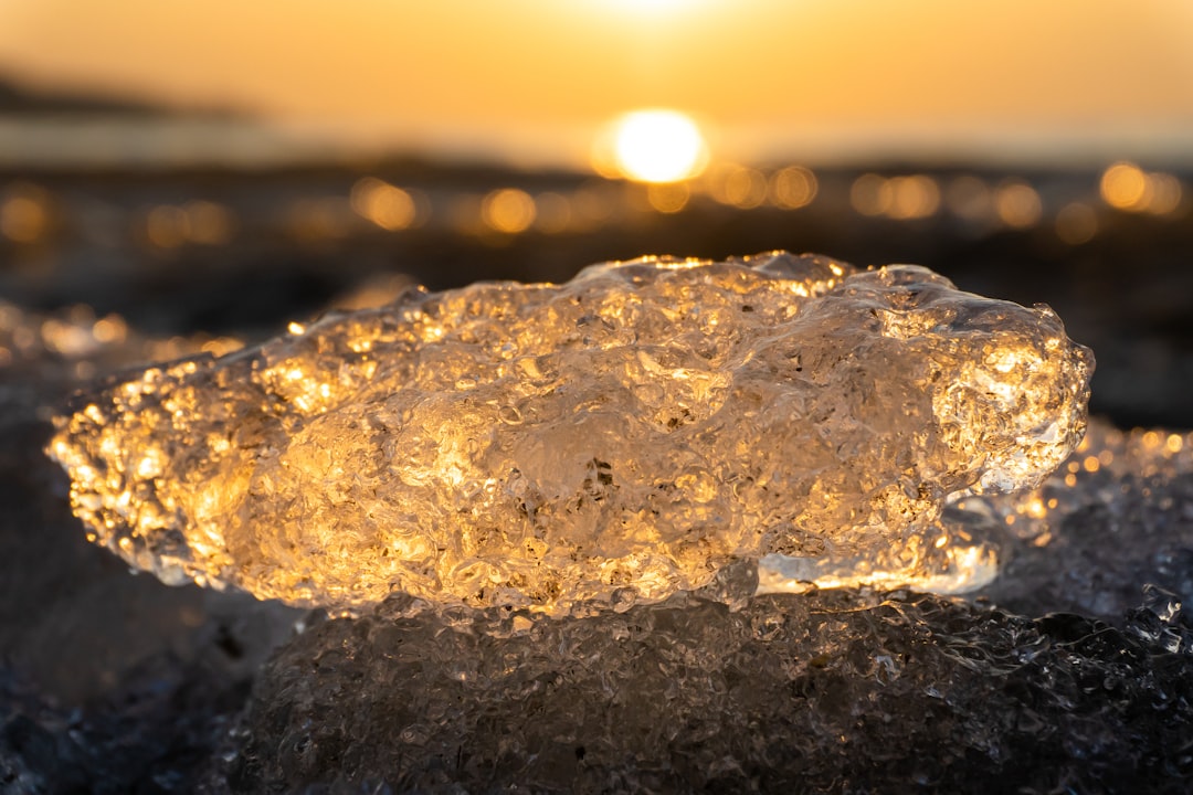 water splash on black rock during sunset