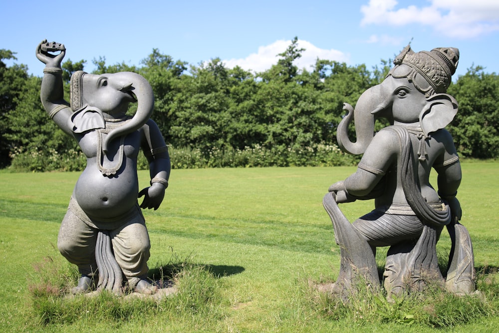 gray elephant statue on green grass field during daytime