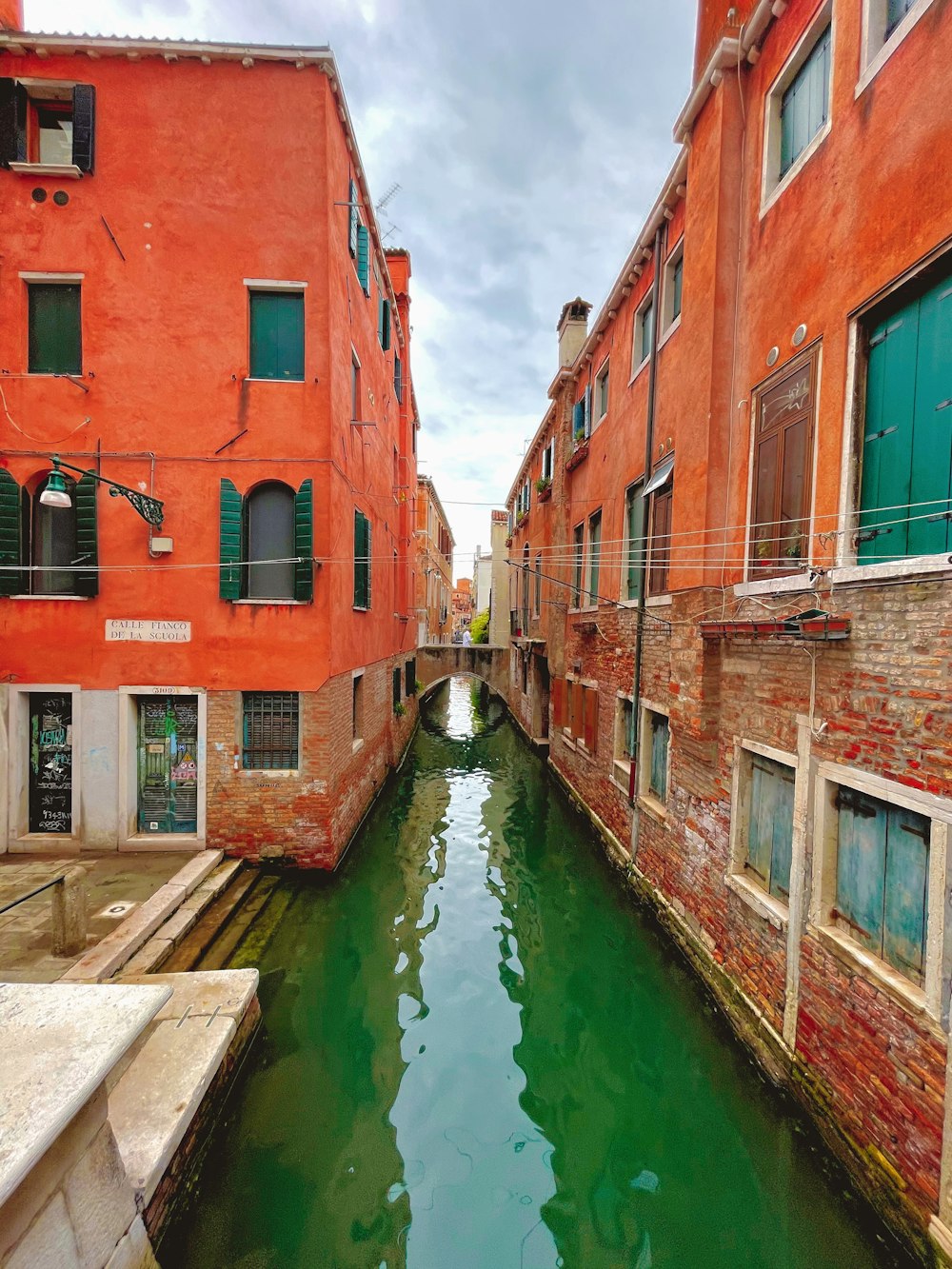 red and brown concrete building beside river during daytime