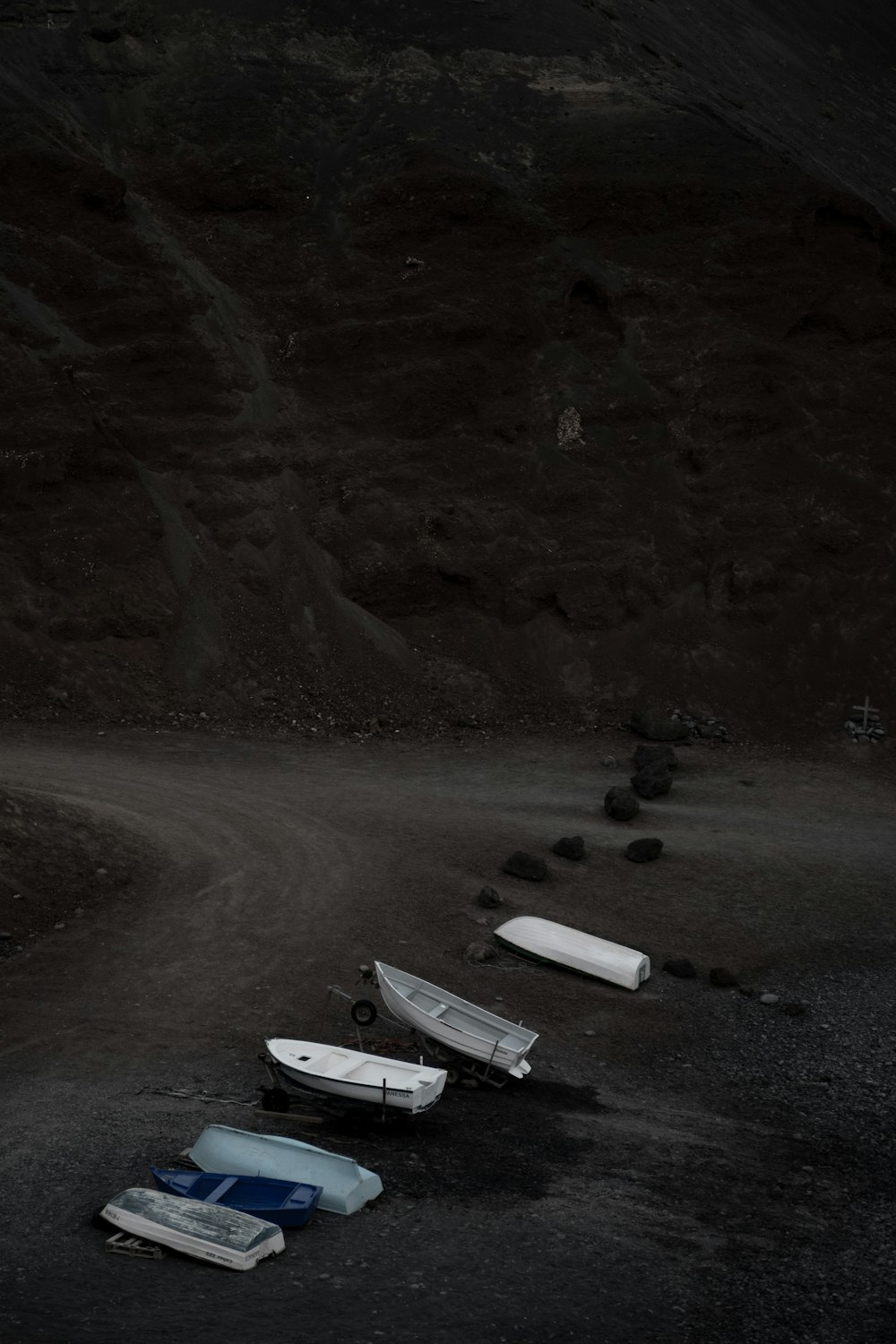 white and black boat on white sand