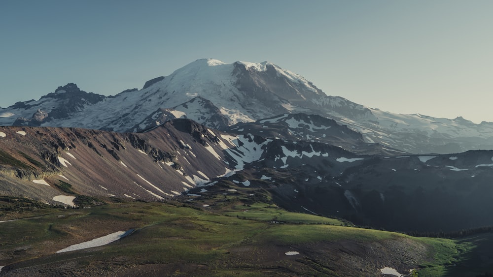 green grass field and mountain during daytime