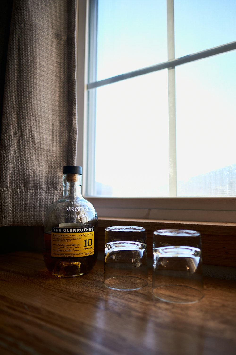 clear glass bottles on brown wooden table