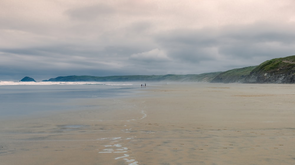 person walking on beach during daytime