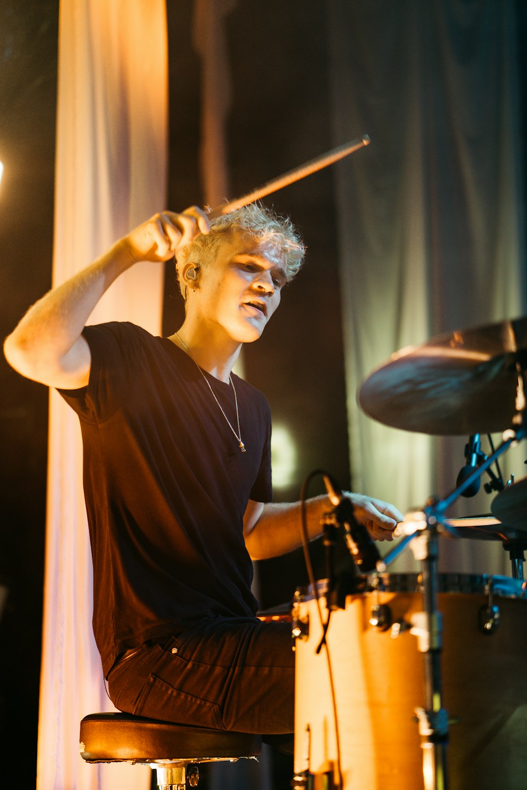 man in black crew neck t-shirt playing drum