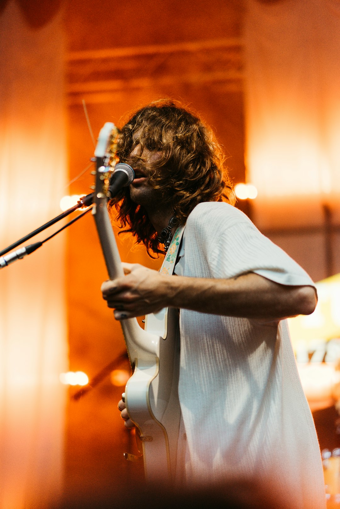 woman in white dress holding microphone