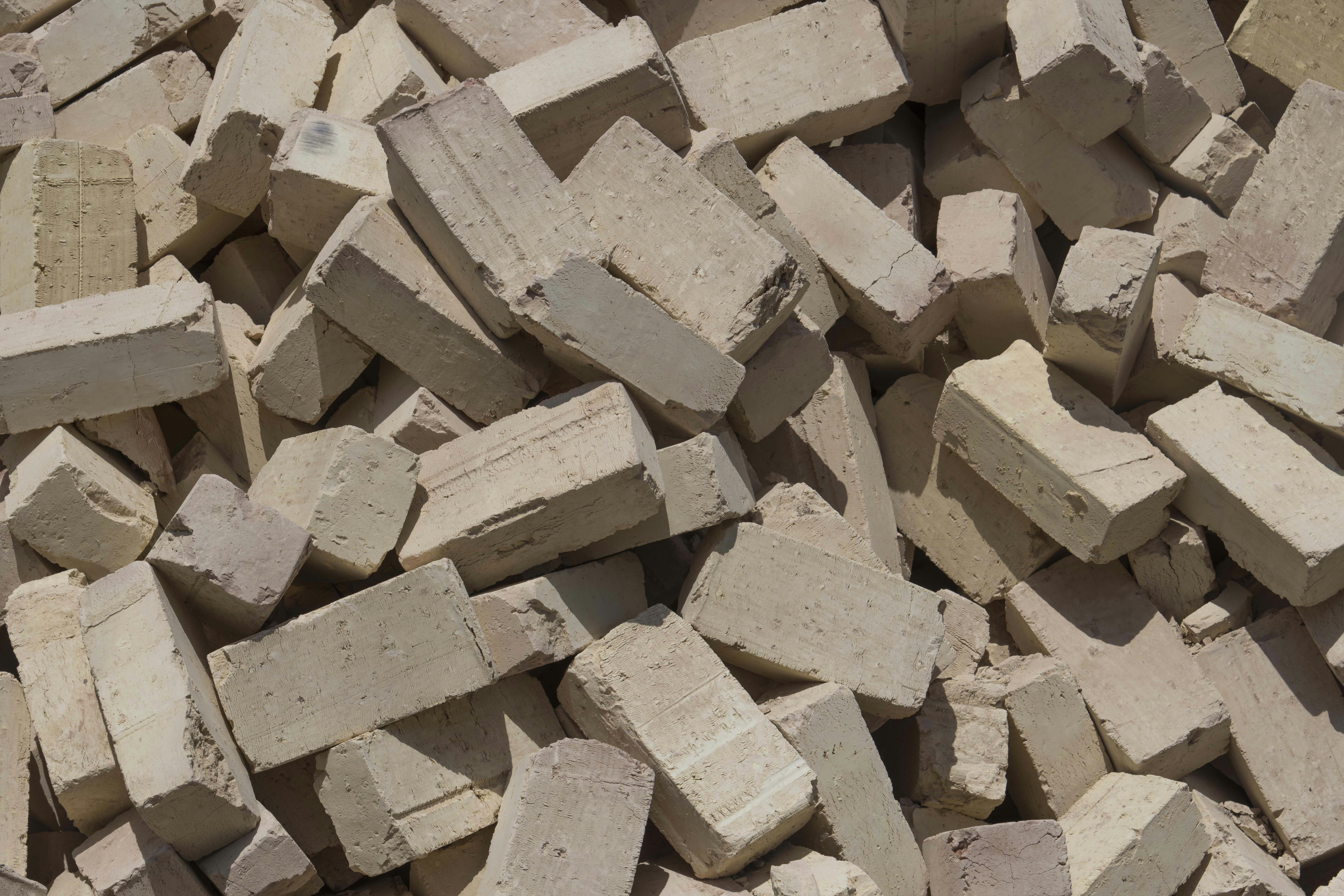 An experienced wallpaper installer carefully applying a sheet of wallpaper to a wall.