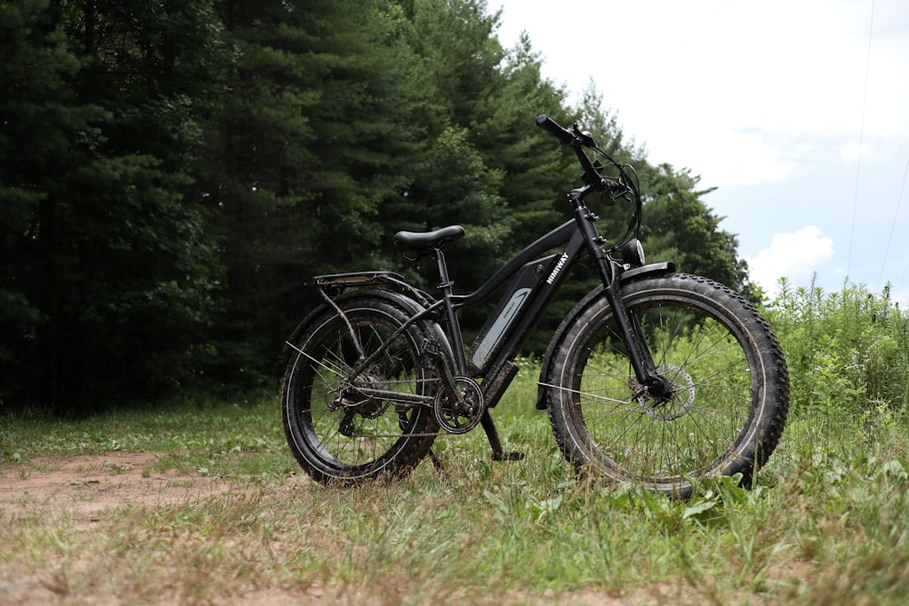 black and gray mountain bike on green grass field