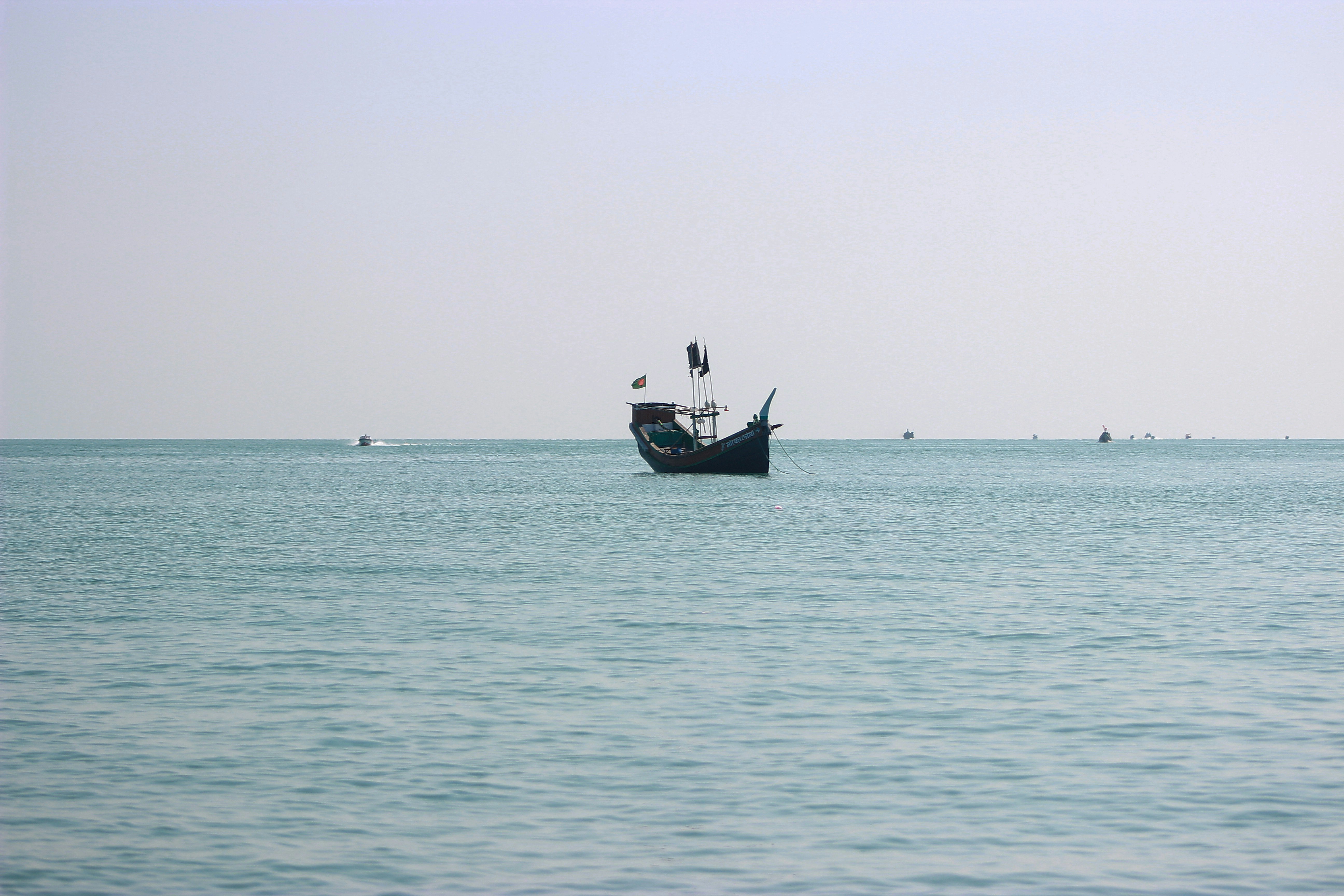a boat floating on top of a large body of water