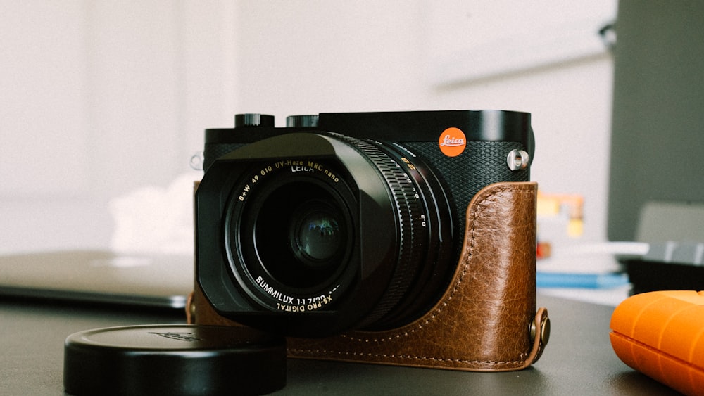 black nikon dslr camera on brown wooden table