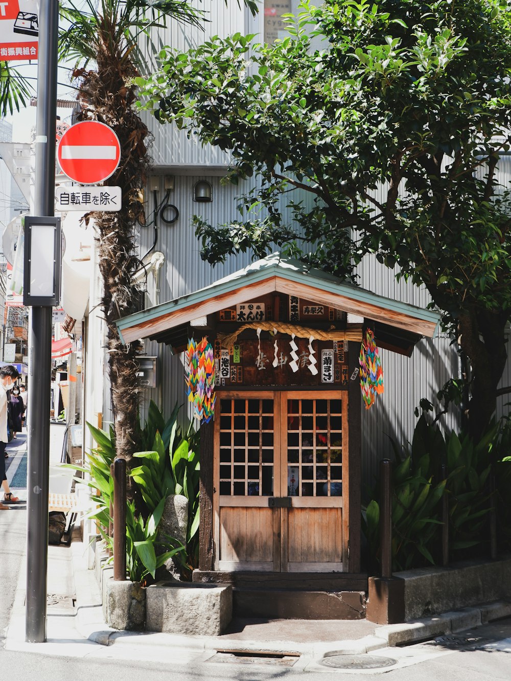 a small wooden building sitting on the side of a road