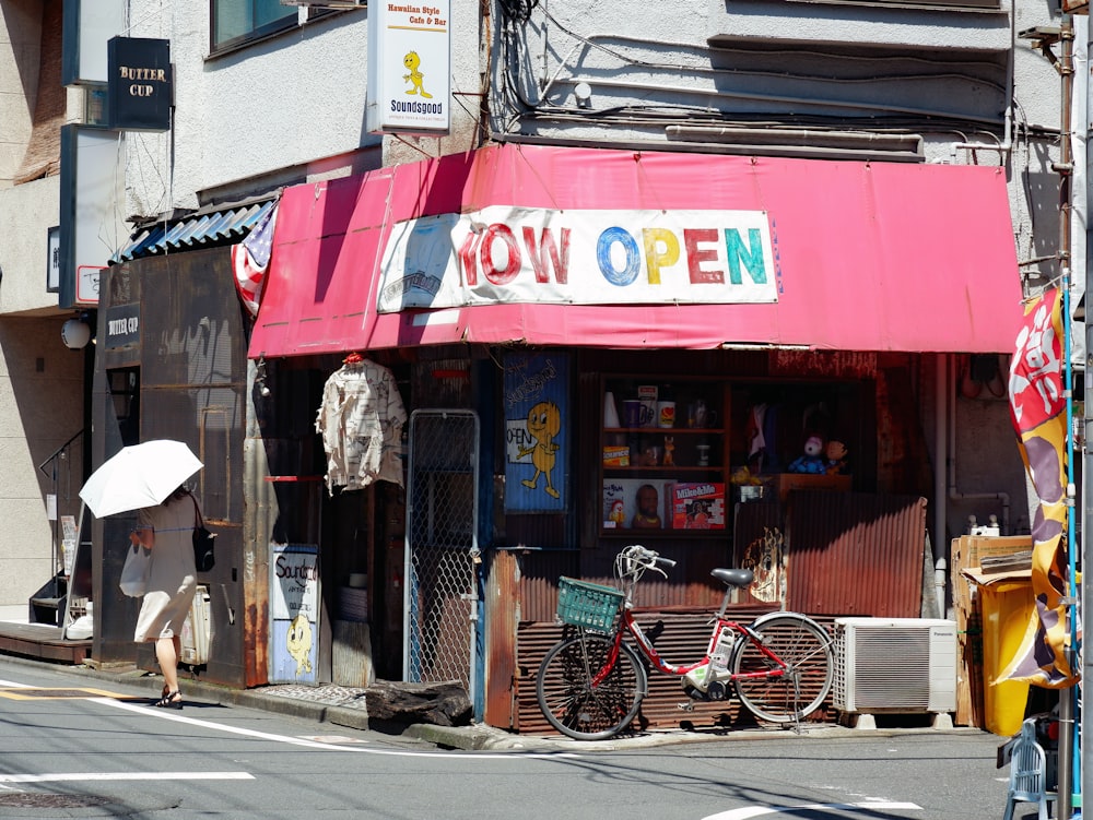 a person with an umbrella walking down a street