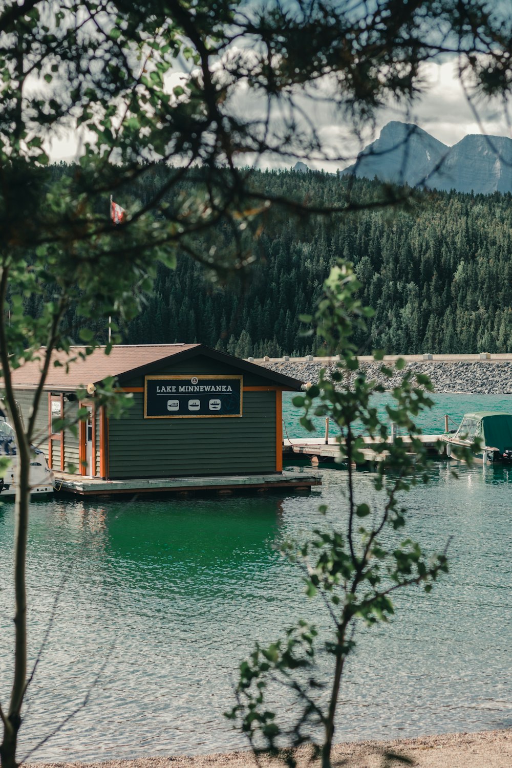 brown wooden house near lake during daytime