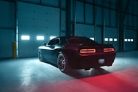 Black muscle car rear three-quarter — exhaust application reference