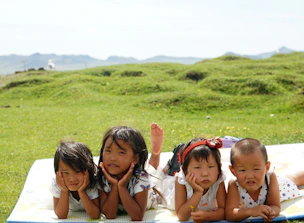 group of girls on green grass field during daytime