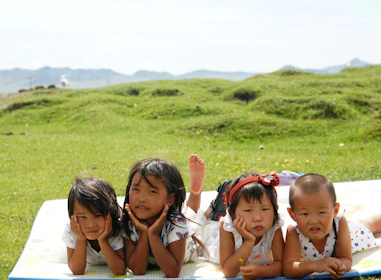 group of girls on green grass field during daytime