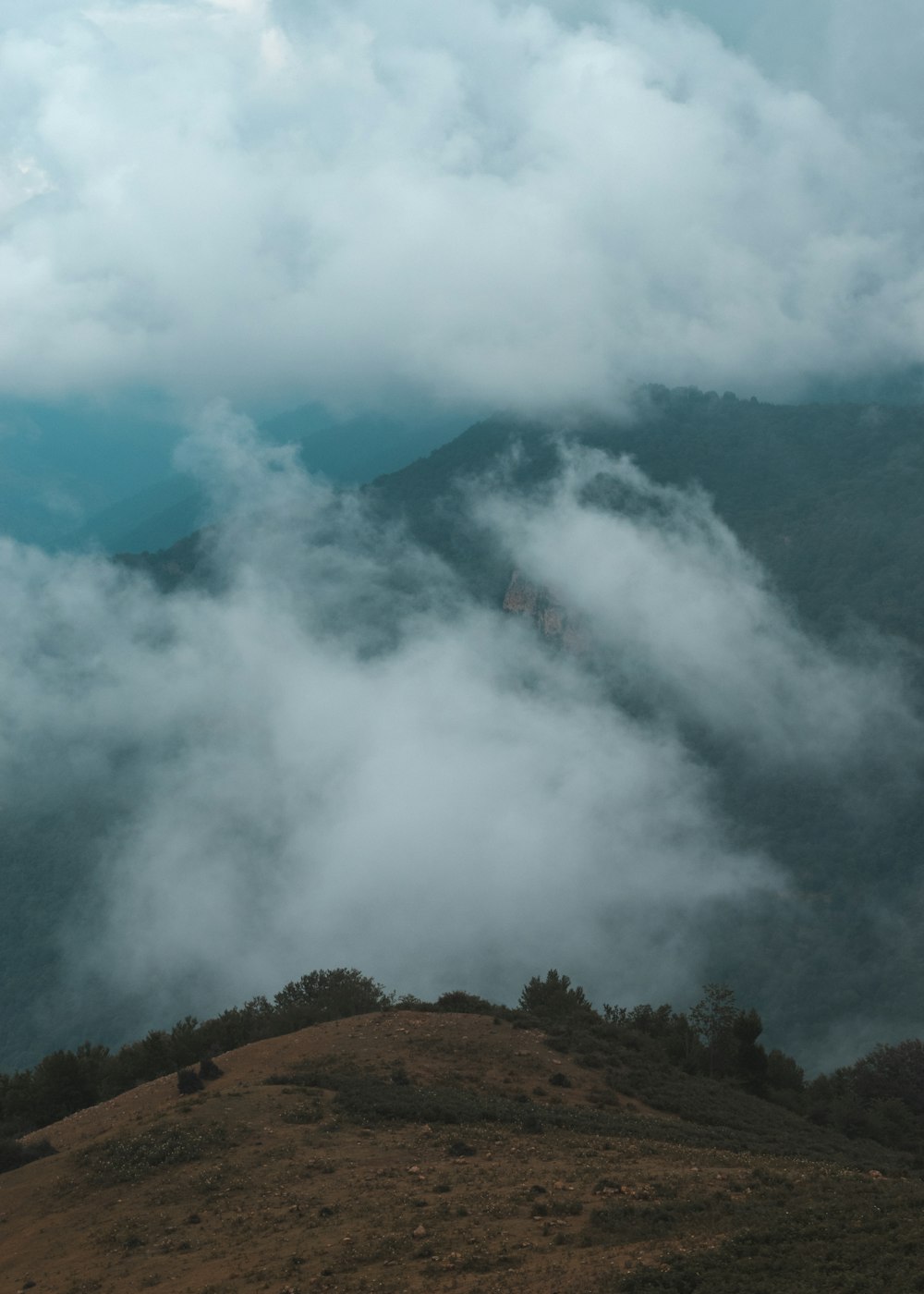 green and brown mountain under white clouds