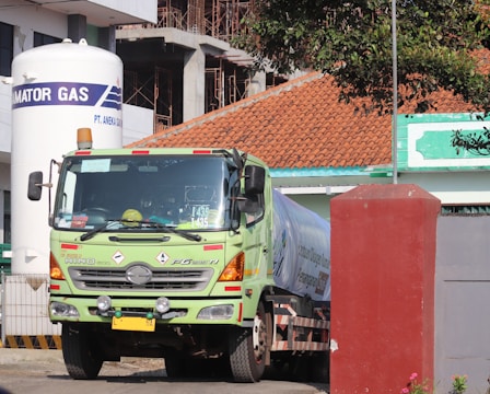 green and white truck on road during daytime