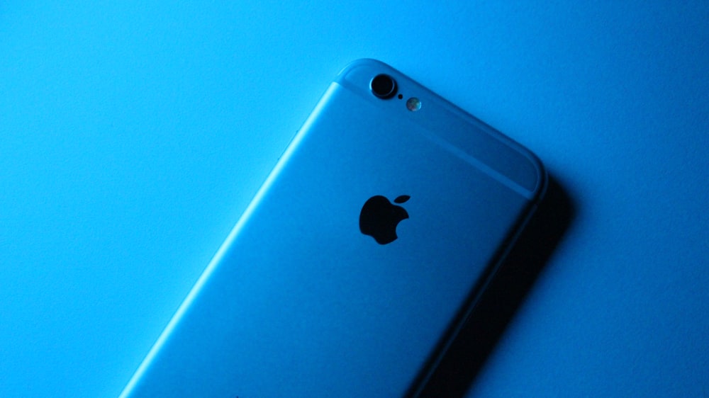 silver iphone 6 on blue surface