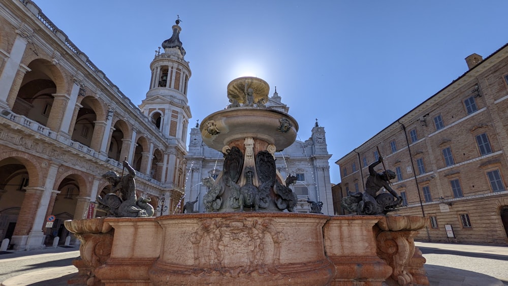 gold statue in front of white concrete building during daytime