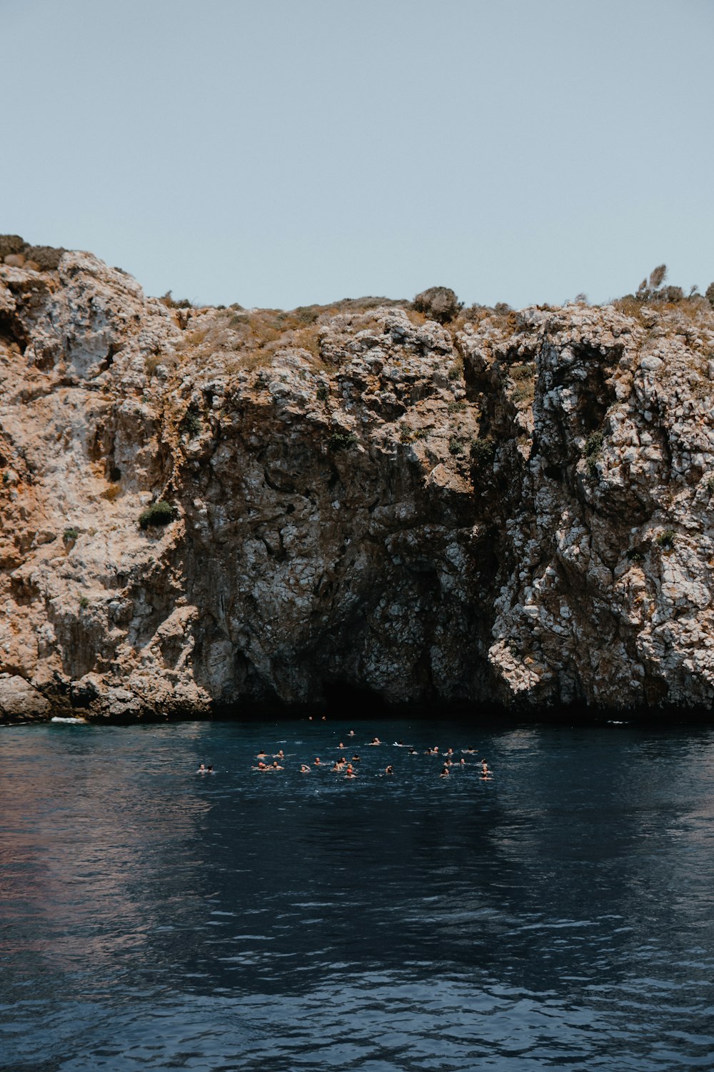 brown rock formation on sea during daytime