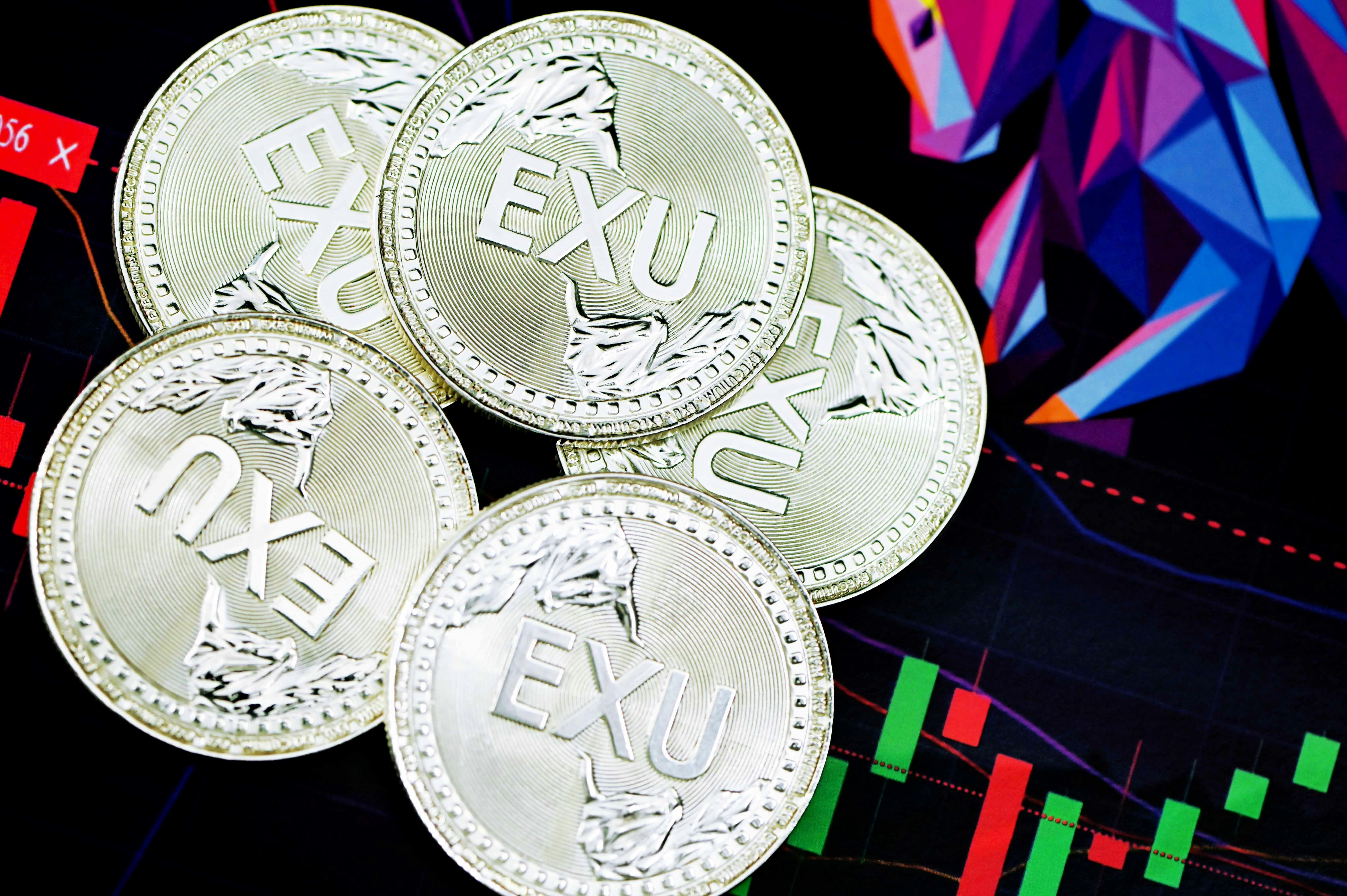 silver round coin on blue and red textile